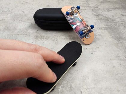 fingers play a finger-skateboard